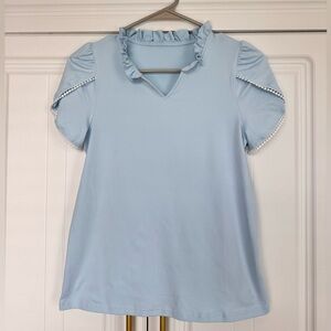 Sky Blue Ruffled Kids Blouse fits like a woman’s small